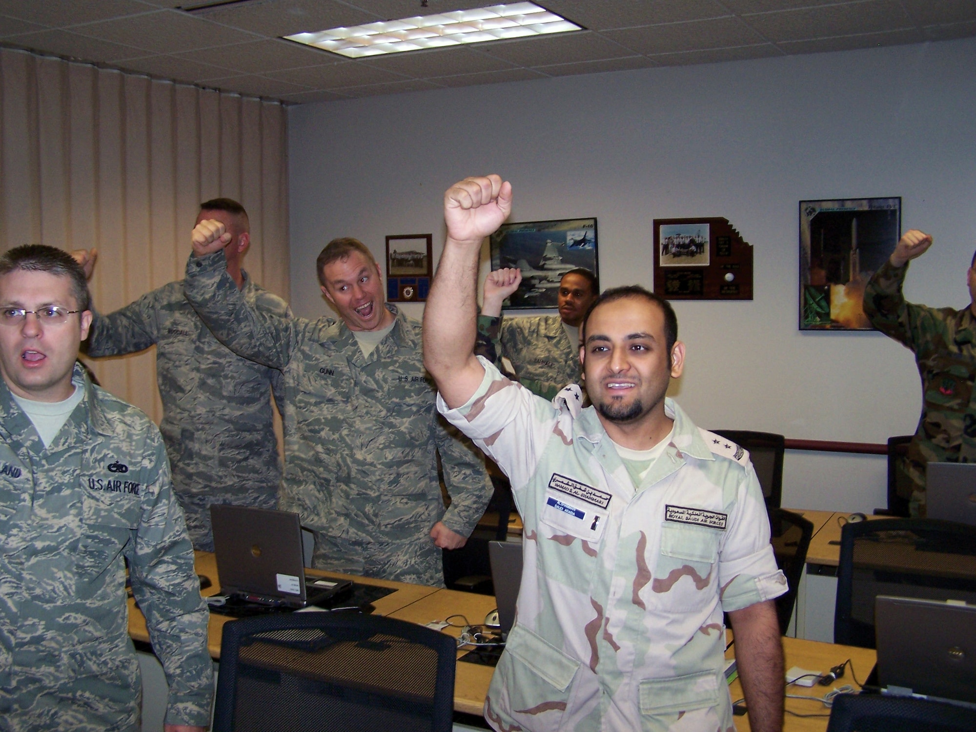 Royal Saudi Air Forces 1st Lt. Hamad Al-Shammari, right, does the cheer, ?Boy, am I enthusiastic!? with his classmates at Lackland's Air Force Recruiting School. He and his 10 classmates graduated June 13.
(USAF photo by Tech. Sgt. Delores Codrington)