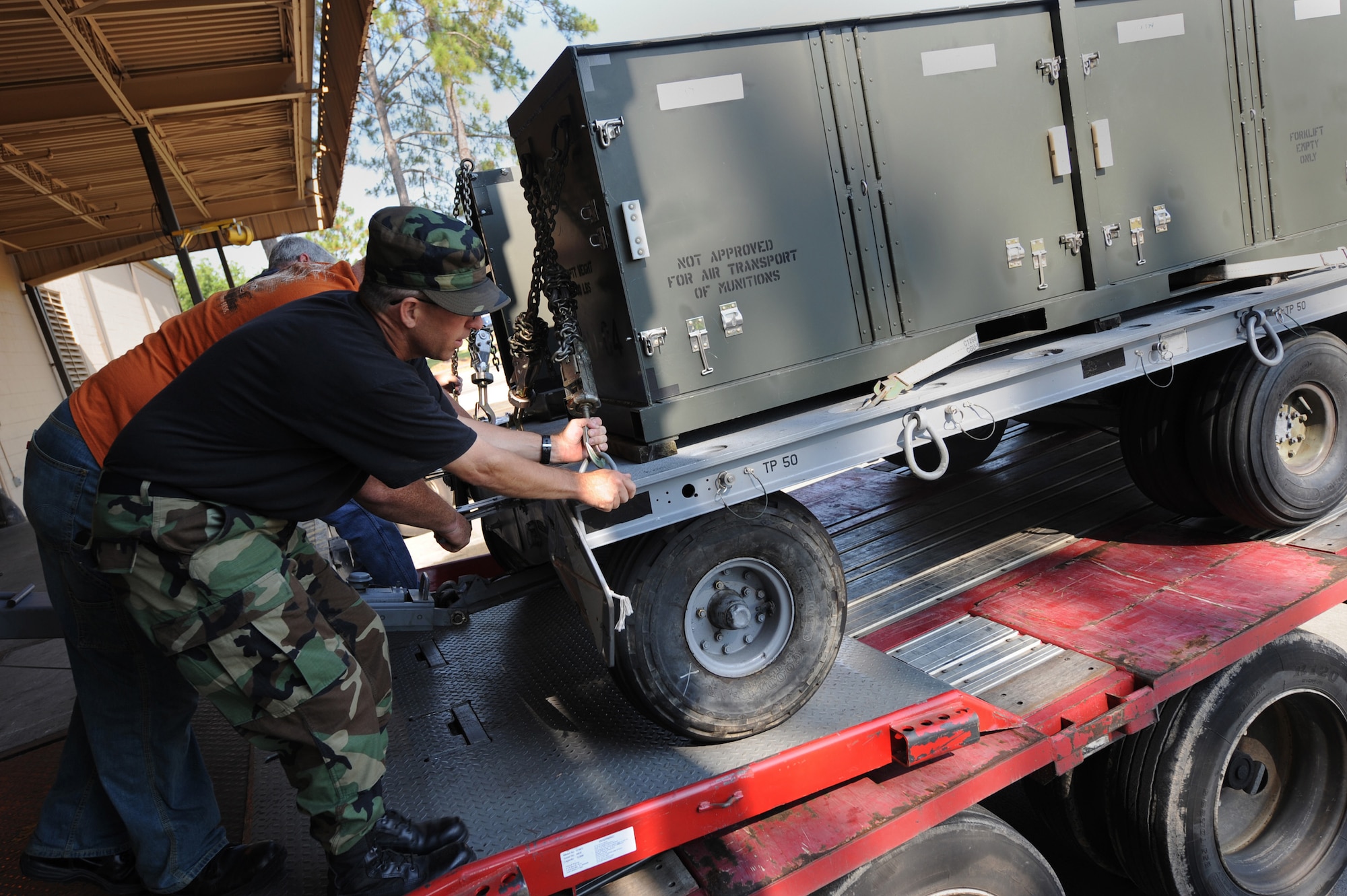 MOODY AIR FORCE BASE, Ga. -- Members of the 23rd Logistics Readiness Squadron push a munitions trailer onto a semi-truck here June 12. The trucks were being loaded with A-10C Thunderbolt II equipment for exercise Atlantic Strike at MacDill Air Force Base, Fla. (U.S. Air Force photo by Senior Airman Gina Chiaverotti)
