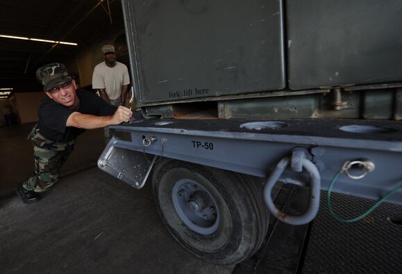 MOODY AIR FORCE BASE, Ga. -- Master Sgt. Ilan Cribb, 23rd Logistics Readiness Squadron NCO-in-charge of cargo movement, pushes a munitions trailer on to a semi-truck here June 12. The munitions were transported to MacDill Air Force Base, Fla., in support of the 23rd Wing's participation in the Atlantic Strike exercise. (U.S. Air Force photo by Senior Airman Gina Chiaverotti) 
