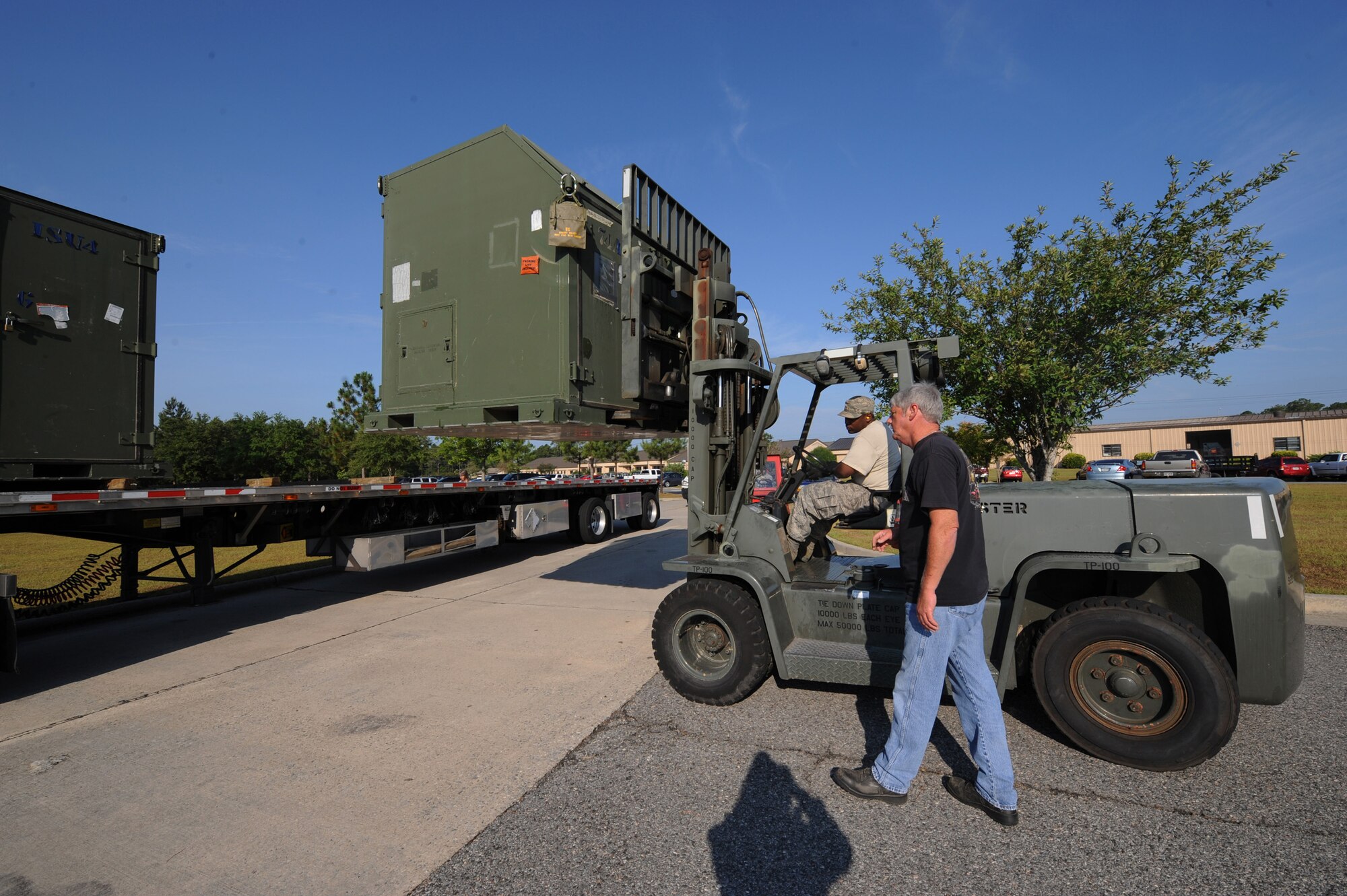 MOODY AIR FORCE BASE, Ga. -- Staff Sgt. Edwin Johnson, 23rd Logistics Readiness Squadron traffic manager craftsman, prepares to put an A-10C Thunderbolt II maintenance kit on to a semi-truck while Terry Mccard, 23rd LRS packing and crating supervisor, directs him here June 12. The semi-truck is transporting the equipment to MacDill Air Force Base, Fla., for exercise Atlantic Strike. (U.S. Air Force photo by Senior Airman Gina Chiaverotti)