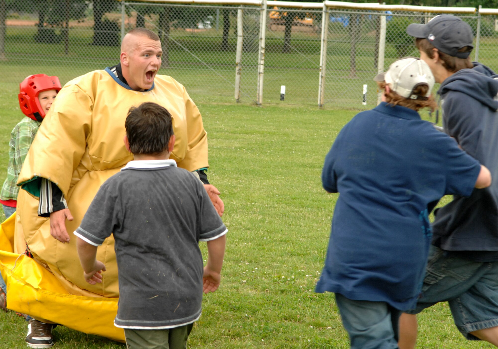 SPANGDAHLEM AIR BASE, Germany—Herr Marcel Follmann, 52nd Security Forces Squadron, plays with orphans from St. Vinzenshaus in a “sumo suit” June 14, 2008.  The children came to Spangdahlem on a field trip to learn more about what the military does.  (U.S. Air Force photo by Senior Airman Logan Tuttle.)