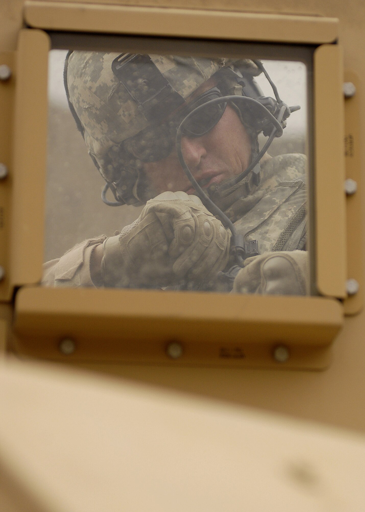 PANJSHIR PROVINCE, Afghanistan - Tech. Sgt. Domenick Demasi, Panjshir Provincial Reconstruction Team Security Forces NCO-in-charge, prepares for a convoy mission behind a window turret on an Humvee. Sergeant Demasi is deployed from 99th Security Forces Group, Nellis Air Force Base, Nev. (U.S. Air Force photo by Master Sgt. Demetrius Lester)