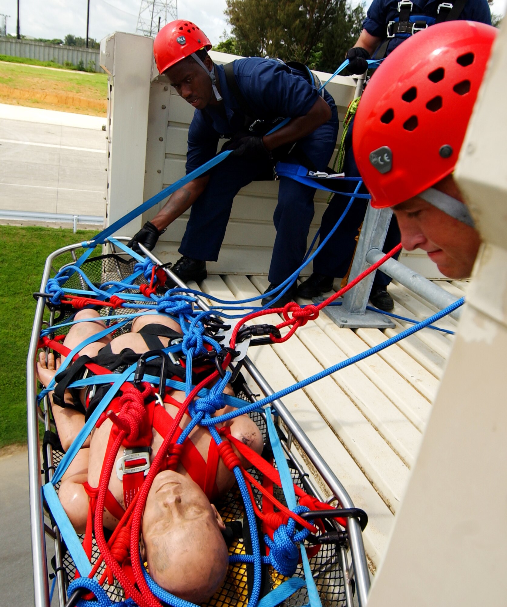 Senior Airman Brett Williams, 3rd Civil Engineer Squadron, Elmendorf Air Force Base, Alaska, and Senior Airman Derek White, 18th Civil Engineer Squadron, Kadena Air Base, Japan, hoist down a simulated injured victim during the Rescue I course provided by Detachment 1, 554th Rescue Squadron at Kadena Air Base, Japan, June 17.
(U.S. Air Force photo/Tech. Sgt. Rey Ramon)
