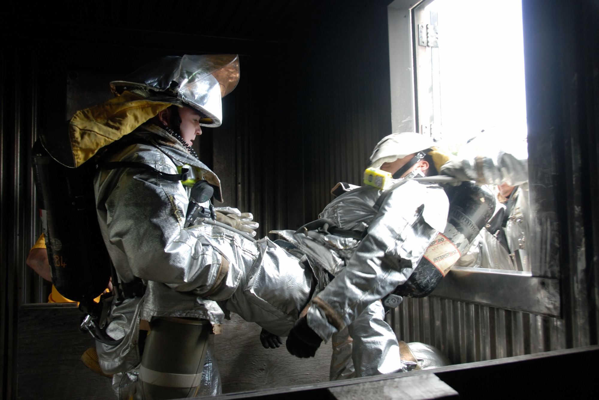 MISAWA AIR BASE, Japan -- Senior Airman Brandon Vines, 35th CES, performs the Denver Drill with fellow firefighters on June 13, 2008.  The drill provides the skills necessary to rescue trapped firefighters from tight spaces and remove them through windows and small openings. The drill was one of several techniques taught during a week-long training course that covered rescue and evacuation maneuvers.  (U.S. Air Force photo by Senior Airman Laura R. McFarlane)