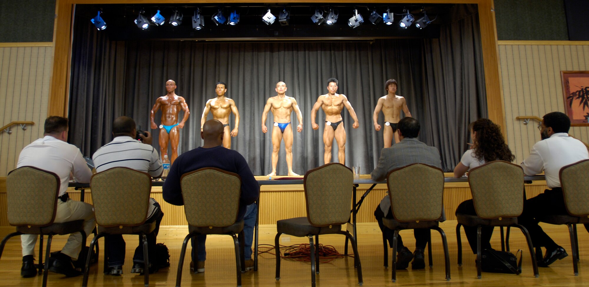 MISAWA AIR BASE, Japan -- Five men competing against each other for the Misawa Body Building Finals pose while being judged on Misawa Air Base, June 15, 2008.  Four Japanese Nationals and only one American competed in this event. (U.S. Air Force photo by Senior Airman Chad Strohmeyer)