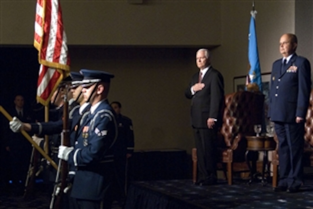 U.S. Defense Secretary Robert M. Gates, center, and U.S. Air Force Gen. Michael V. Hayden, right, director of the Central Intelligence Agency, render honors to the Stars and Stripes during Hayden's retirement ceremony on Bolling Air Force Base in Washington D.C., June 20, 2008. Hayden will continue serving as the agency's director as a civilian.
