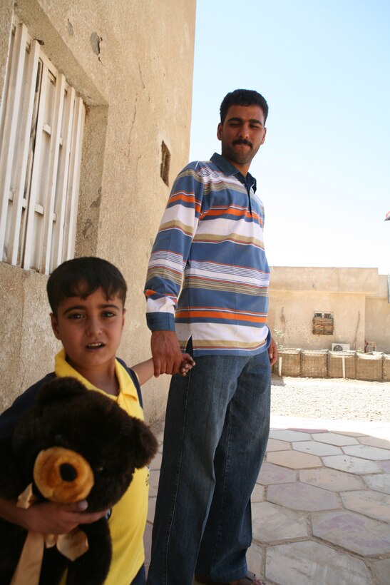 Five-year-old Ahmed and his father, Warrant Officer Othman Mallouki, an Iraqi policeman with Fallujah Headquarters District, get ready to leave the Joint Command Center after a visit with Marines from Company B, Police Transition Team 8, Regimental Combat Team 1, June 21. Marines with the team are working with the family to arrange transportation for Ahmed’s surgery in Jordan. (Official Marine Corps photo by Cpl. Chris T. Mann)