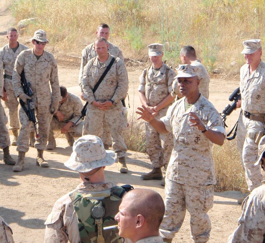 Lt. Cmdr. Kobena Arthur, the chaplain with 2nd Battalion, 25th Marine Regiment, Regimental Combat Team 5, gives a motivational speech to Marines and sailors at Camp Pendleton, Calif., June 17.  Arthur exclaimed, "Keep on!" to which the troops responded, "Keeping on!"  This adage has become a catch-phrase for the Marines of the battalion throughout their pre-deployment training and current mission in Iraq.  ::r::::n::::r::::n::