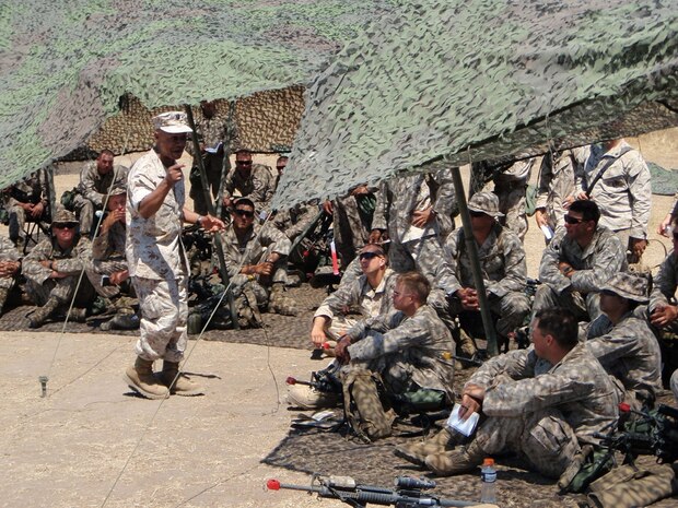 Lt. Cmdr. Kobena Arthur, the chaplain with 2nd Battalion, 25th Marine Regiment, Regimental Combat Team 5, delivers a Sunday church service at a remote training site at Camp Pendleton, Calif., June 22.  A minister of more than 25 years, Arthur is serving in Iraq for the first time.  In addition to three masterâ??s degrees, including his most recent in health law and policy, Arthur holds a doctorate in psychology and another in education administration and counseling.  ::r::::n::::r::::n::