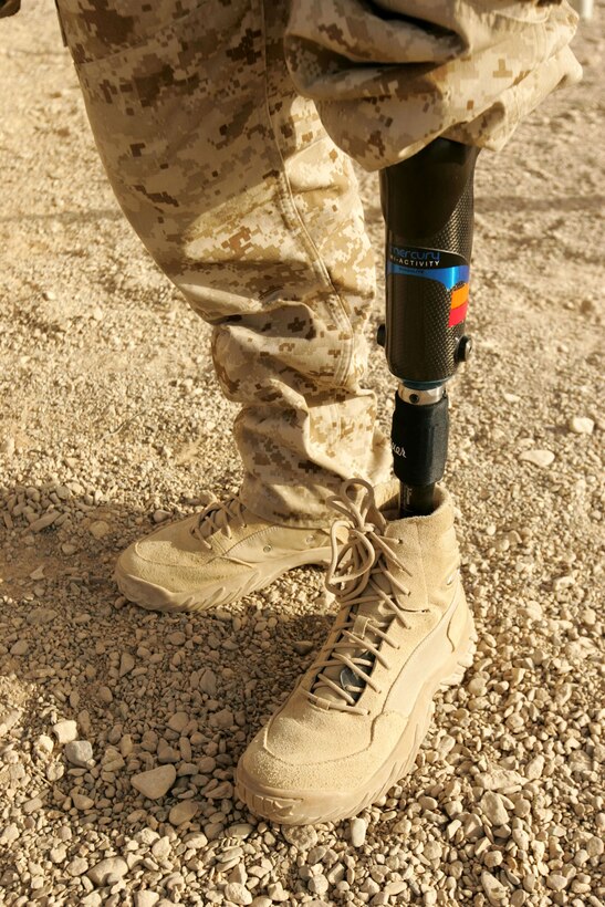 Corporal Garrett S. Jones displays one of the seven prosthetic legs he now wears after being injured in 2007 by an insurgent’s bomb during his unit’s deployment to Iraq.  Six of his legs are used for walking, and one is for snowboarding.