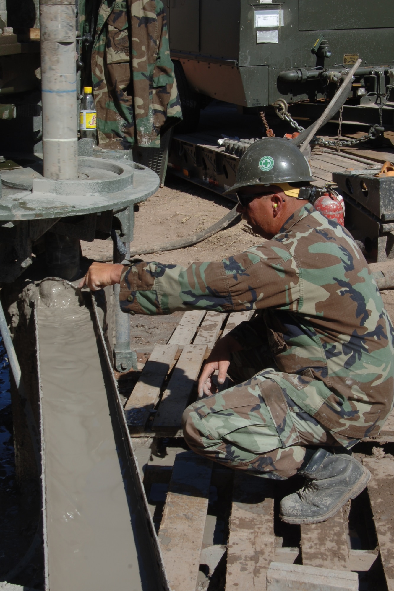 U.S. Navy Petty Officer 1st Class Mark Goff, a lead driller assigned to Task Force New Horizons, checks the mudding cut of a drill bit being used to construct a water well in Huanta, Peru, June 19, in support of New Horizons - Peru 2008, a U.S. and Peruvian humanitarian mission set on providing relief to underprivileged Peruvians.  (U.S. Air Force photo/Tech. Sgt. Kerry Jackson)