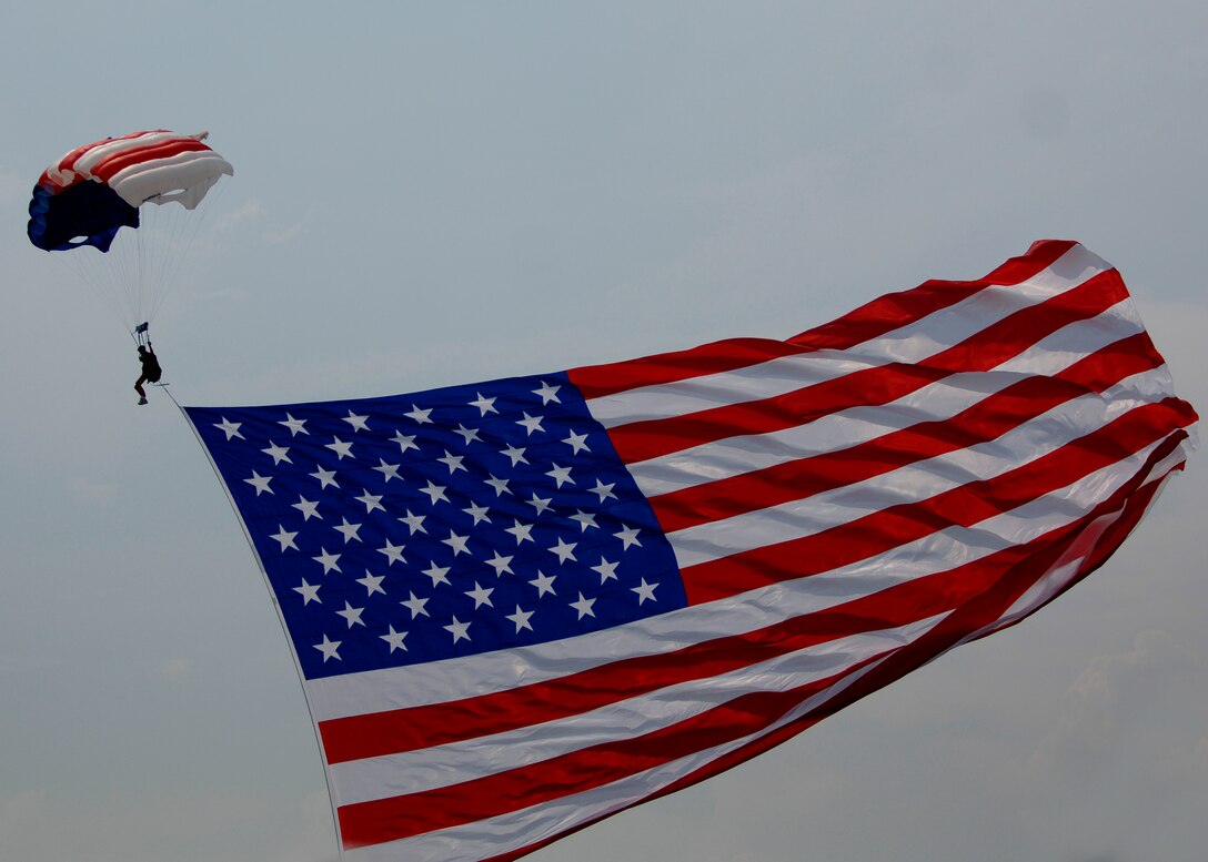 LANGLEY AIR FORCE BASE, Va. - An E Team skydiver displays an American flag during AirPower over Hampton Roads here June 21.  Langley’s open house is an annual event that helps educate the public, increase recruiting and show appreciation to the local community. (U.S. Air Force photo/Tech. Sgt. Levi Collins)