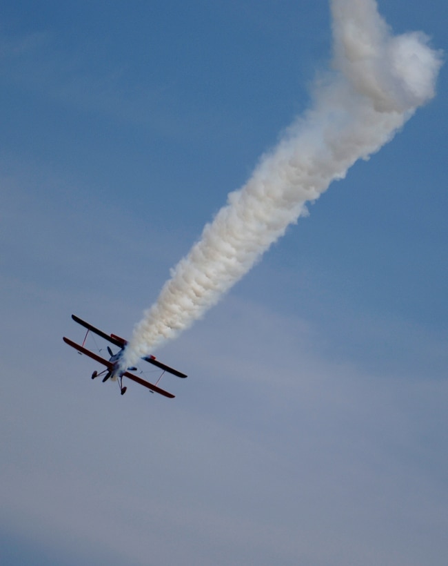 LANGLEY AIR FORCE BASE, Va. -- Ed Hamill flies an Air Force Reserve biplane during AirPower over Hampton Roads here June 21. Langley’s open house is an annual event that helps educate the public, increase recruiting and show appreciation to the local community. “It's a chance to get people informed, involved and excited,” said Lt. Col. Brady Merrill, director of AirPower over Hampton Roads and chief of 1st Fighter Wing Plans, Programs and Evaluations. (U.S. Air Force photo/Tech.Sgt. Levi Collins)