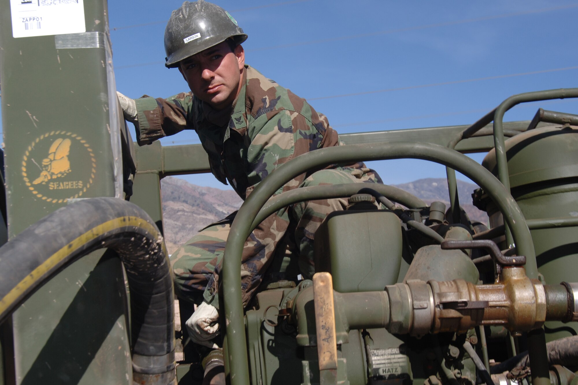 U.S. Navy Petty Officer 2nd Class Paul Larson, a lead welder assigned to Task Force New Horizons, fills a water well rig with fuel, June 19, in Huanta, Peru, where U.S. Navy Seabeas are constructing a water well in support of New Horizons Peru 2008, a U.S. and Peruvian humanitarian mission set on providing relief to underprivileged Peruvian. (U.S. Air Force photo/Tech. Sgt. Kerry Jackson)