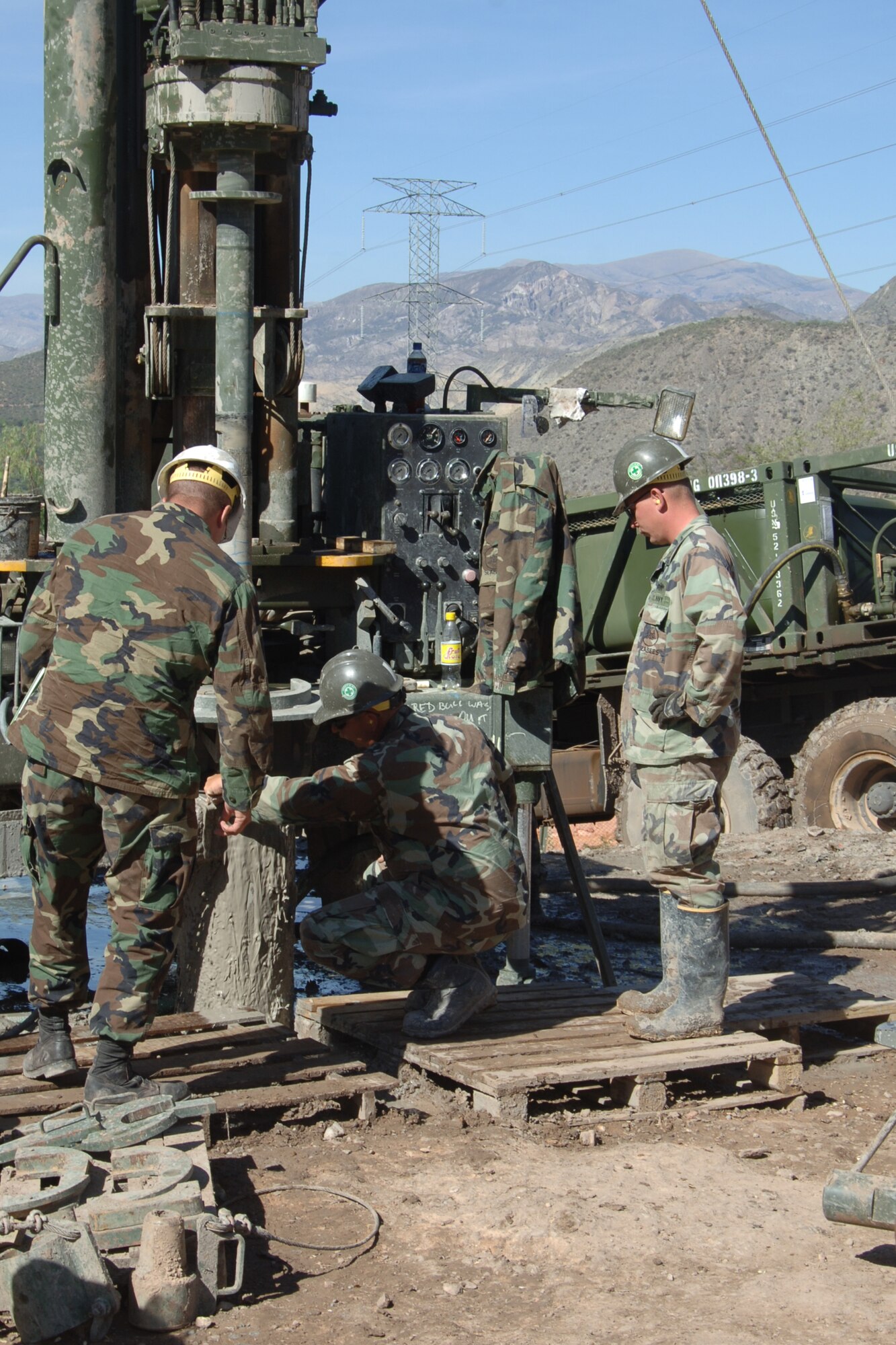 U.S. Navy Chief Petty Officer Matthew Turner, construction site chief assigned to Task Force New Horizons, and Petty Officer 1st Class Mark Goff, Task Force New Horizons lead driller, inspects a drill in Huanta, Peru, where U.S. Navy Seabees are drilling a water well in support of New Horizons Peru-2008, a U.S. and Peruvian humanitarian mission set on providing relief to underprivileged Peruvians. (U.S. Air Force photo/Tech. Sgt. Kerry Jackson)