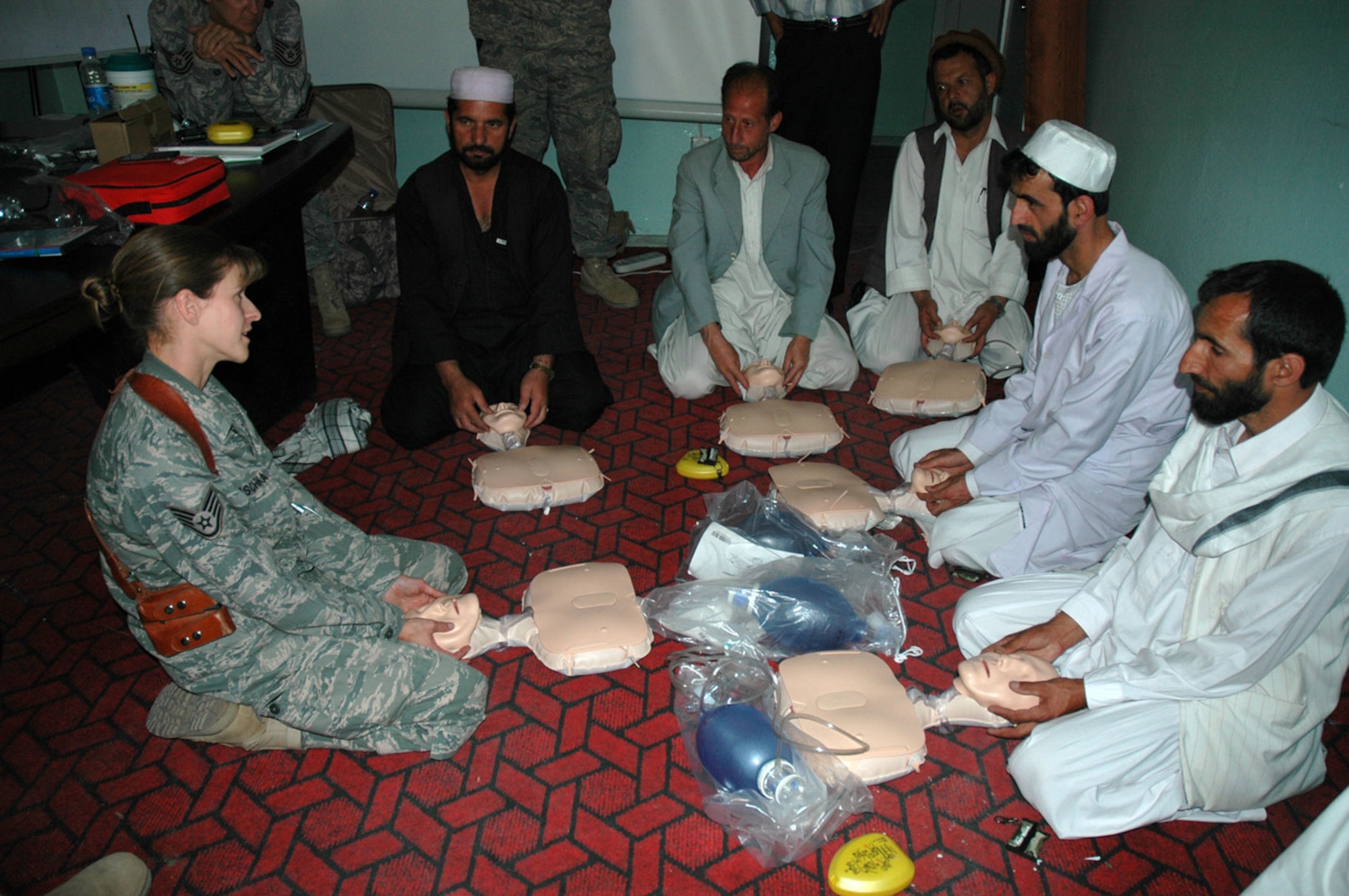 PANJSHIR PROVINCE, Afghanistan -- Staff Sgt. Janine Duschka, a Panjshir Provincial Reconstruction Team medical technician, teaches infant CPR to Afghan medical providers during a CPR class at the Rokha Clinic here June 18.  This was the first of a 15-class CPR program that the Panjshir PRT is providing this year. (U.S. Air Force photo by Capt. Jillian Torango)