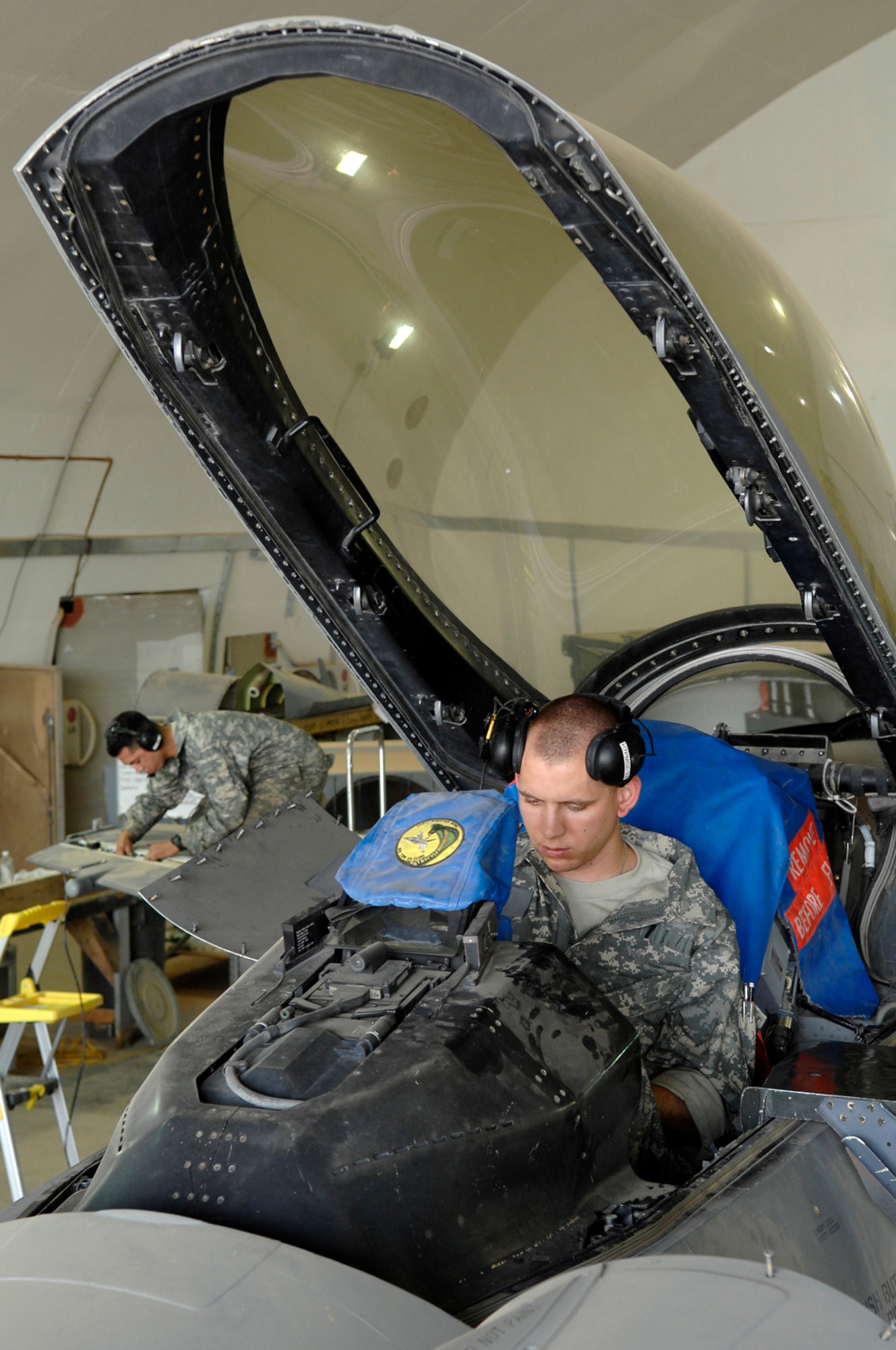 JOINT BASE BALAD, Iraq -- Airman 1st Class Shane Bridges, 332nd Expeditionary Aircraft Maintenance Squadron crew chief, goes through a checklist of items during a phase inspection of an F-16 Fighting Falcon here, June 18. A phase inspection checks critical aircraft systems to ensure they are in working order and can continue to fly combat missions over Iraq. Airman Bridges is deployed from Shaw Air Force Base, S.C. (U.S. Air Force photo/ Senior Airman Julianne Showalter)