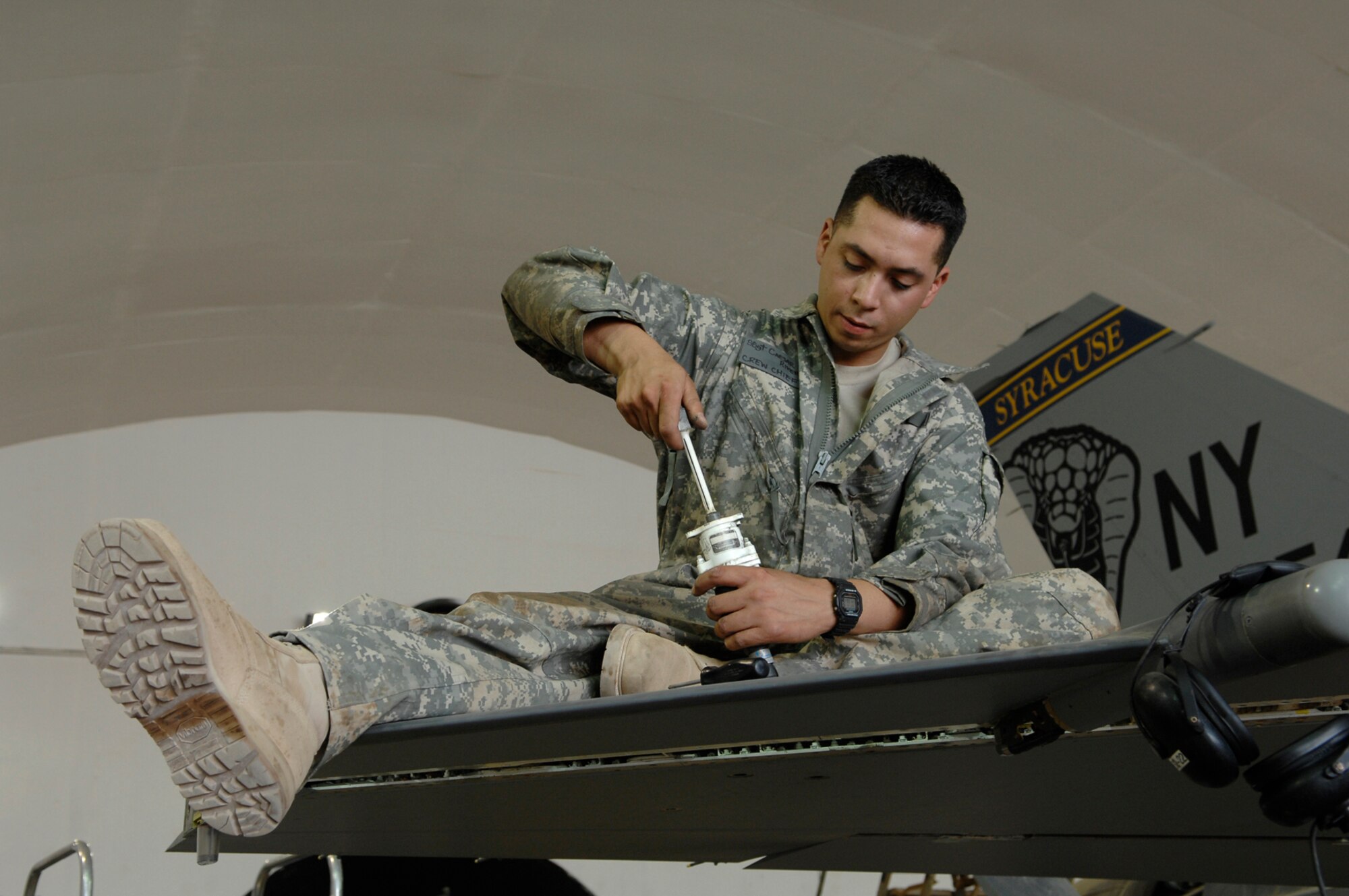 JOINT BASE BALAD, Iraq -- Staff Sgt. Caesar Rivera, 332nd Expeditionary Aircraft Maintenance Squadron crew chief, rotates an actuator for the leading edge flap test of an F-16 Fighting Falcon during a phase inspection here, June 18. The leading edge flap provides additional lift and drag during take off and landing. Sergeant Rivera is deployed from Nellis Air Force Base, Nev. (U.S. Air Force photo/ Senior Airman Julianne Showalter)