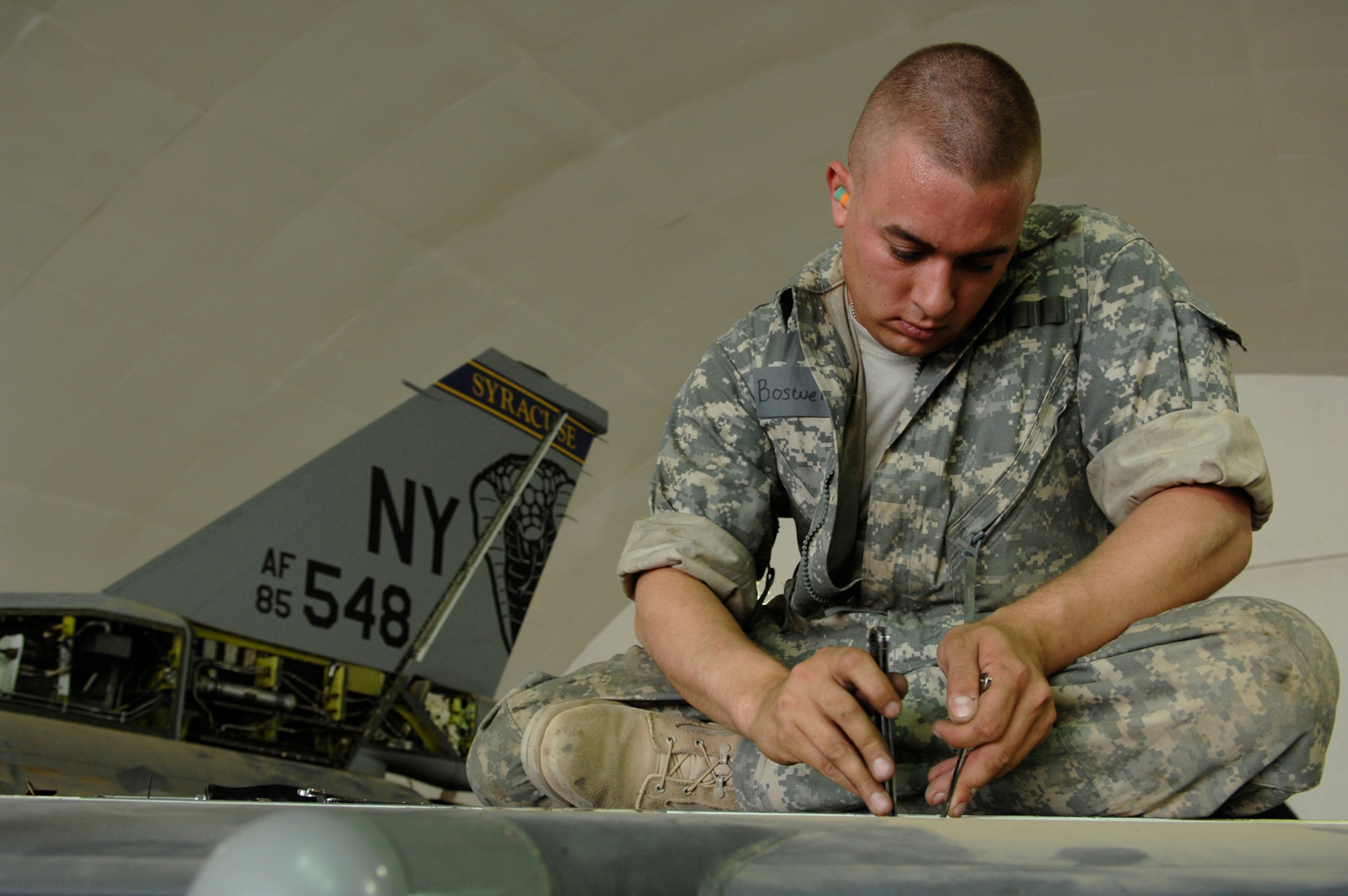 JOINT BASE BALAD, Iraq -- Airman 1st Class Bryan Boswell, 332nd Expeditionary Aircraft Maintenance Squadron crew chief, reinstalls an actuator for the leading edge flap test of an F-16 Fighting Falcon during a phase inspection here, June 18. The leading edge flap creates a cup-like channel of air under the wings, which allows the aircraft to move at slower air speeds. Airman Boswell is both deployed from Nellis Air Force Base, Nev. (U.S. Air Force photo/ Senior Airman Julianne Showalter)