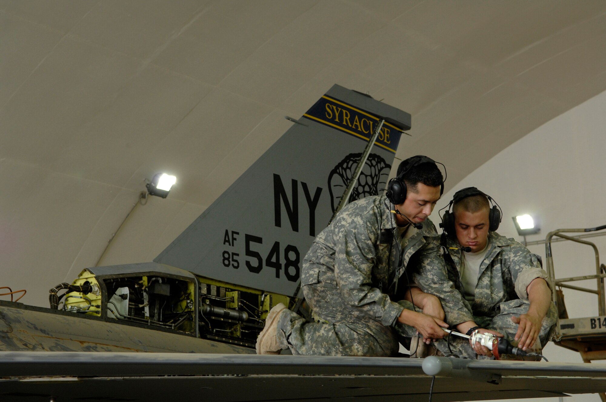 JOINT BASE BALAD, Iraq -- Staff Sgt. Caesar Rivera and Airman 1st Class Bryan Boswell, 332nd Expeditionary Aircraft Maintenance Squadron crew chiefs, test an actuator, a device used to control aircraft flaps, on an F-16 Fighting Falcon during a phase inspection here, June 18. The leading edge flap, which the actuator controls, provides additional lift and drag during take off and landing. Sergeant Rivera and Airman Boswell are both deployed from Nellis Air Force Base, Nev. (U.S. Air Force photo/ Senior Airman Julianne Showalter)