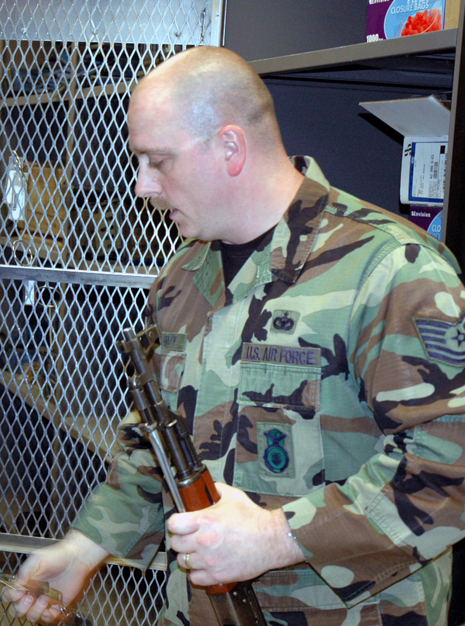 Tech. Sgt. Sean Heraty, U.S. Air Force Expeditionary Center armory, moves an AK-47 into a storage area inside the armory June 19, 2008, on Fort Dix, N.J.  The USAF EC's armory is one of the largest in the Air Force and holds the Air Force's largest inventory of foreign weapons on the U.S.' East Coast.  Largely, the Center's weapons are used for training in numerous expeditionary field courses.  (U.S. Air Force Photo/Tech. Sgt. Scott T. Sturkol)