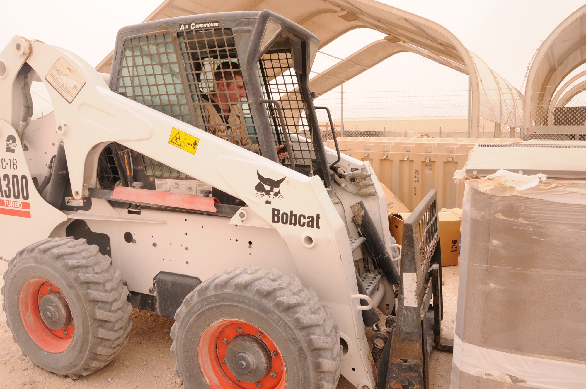 SOUTHWEST ASIA—Cadet Vickers lifts a pallet in a Bobcat. Part of his on-the-job training includes experiencing many areas of the civil engineer squadron to learn more about the labor that keeps the squadron moving. (U.S. Air Force photo/ Senior Airman Domonique Simmons)