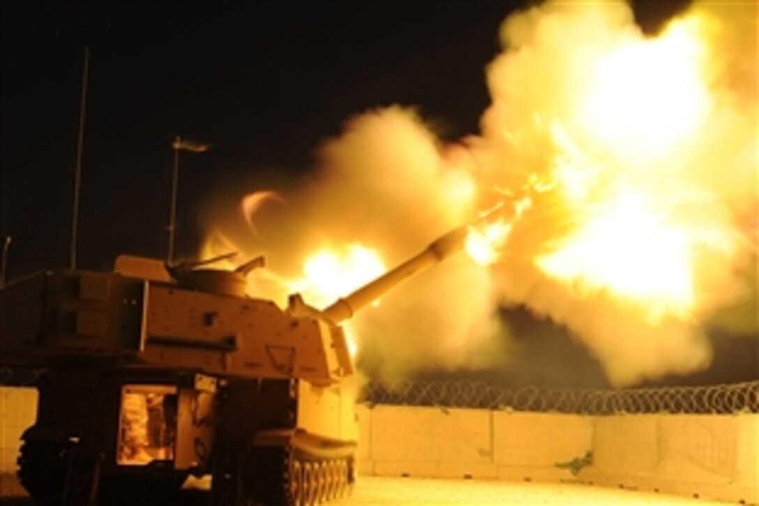 U.S. Air Force Col. David Mansfield, 407th Air Expeditionary Group commander, fires an illumination round from a U.S. Army M-109A6 Paladin self-propelled howitzer on Ali Base, Iraq, in support of Iraqi police patrolling Nasiriyah, Iraq, June 20, 2008. 