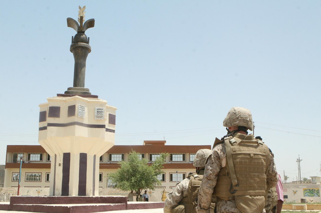 Chief Warrant Officer 2 (closest) and Capt. Angel Torres, both with 1st Battalion, 9th Marine Regiment, gaze at a statue in Ramadi June 22. The battalion helped to secure the city during a seven-month deployment, recently. Now more than a month into their own deployment, Weapons Company, 2nd Battalion, 9th Marine Regiment, Regimental Combat Team 1, has been successful at picking up where their predecessors with 1st Battalion, 9th Marine Regiment, left off.