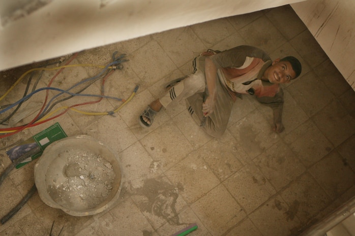 An Iraqi construction worker takes a brief break from work at the newly-constructed 17th Street Municipal Building June 22. The new municipal building is the latest addition to rebuilding efforts in the city. The building, prior to the renovation efforts, was used as a student dormitory. During the intense fighting early in the war, the building was almost destroyed and complete renovations were required to salvage the structure. "The building needed a complete overhaul," said Capt. Angel Torres, the commanding officer of Civil Affairs Detachment 2, Regimental Combat Team 1. "The building was hit by almost every type of munitions known to Coalition forces. It was just a frame with a big hole in the middle of it."