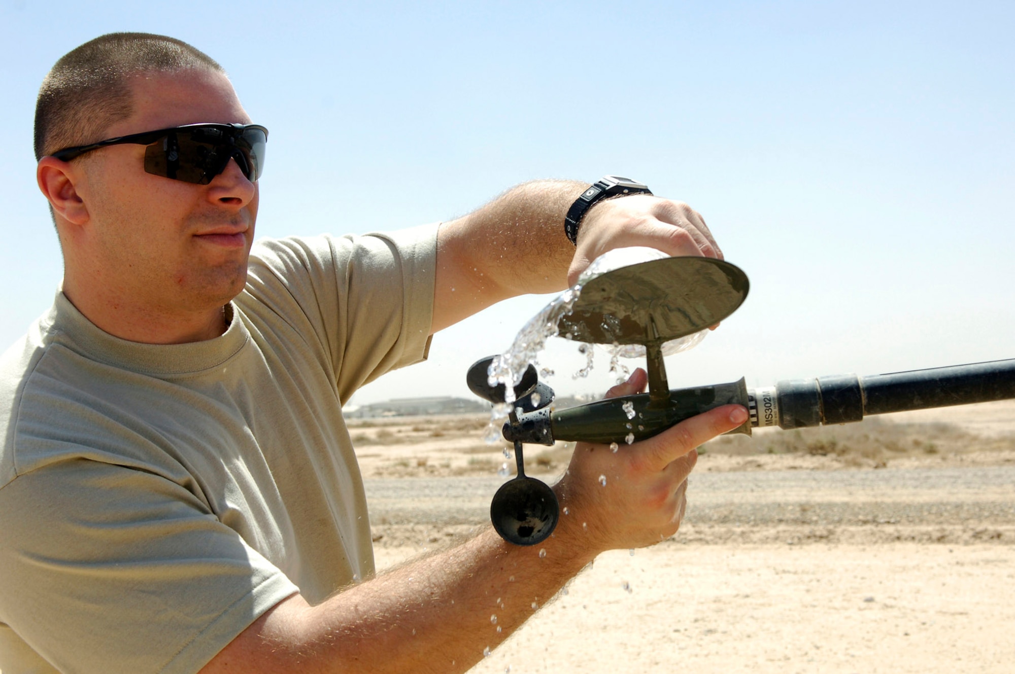 Staff Sgt. Richard Skelly cleans components of the tactical weather equipment suite that measure the wind speed and direction June 14 at Joint Base Balad, Iraq. Sergeant Skelly is a 332nd Expeditionary Operations Support Squadron combat weather forecasterdeployed from Andrews Air Force Base, Md. (U.S. Air Force photo/Staff Sgt. Mareshah Haynes) 
