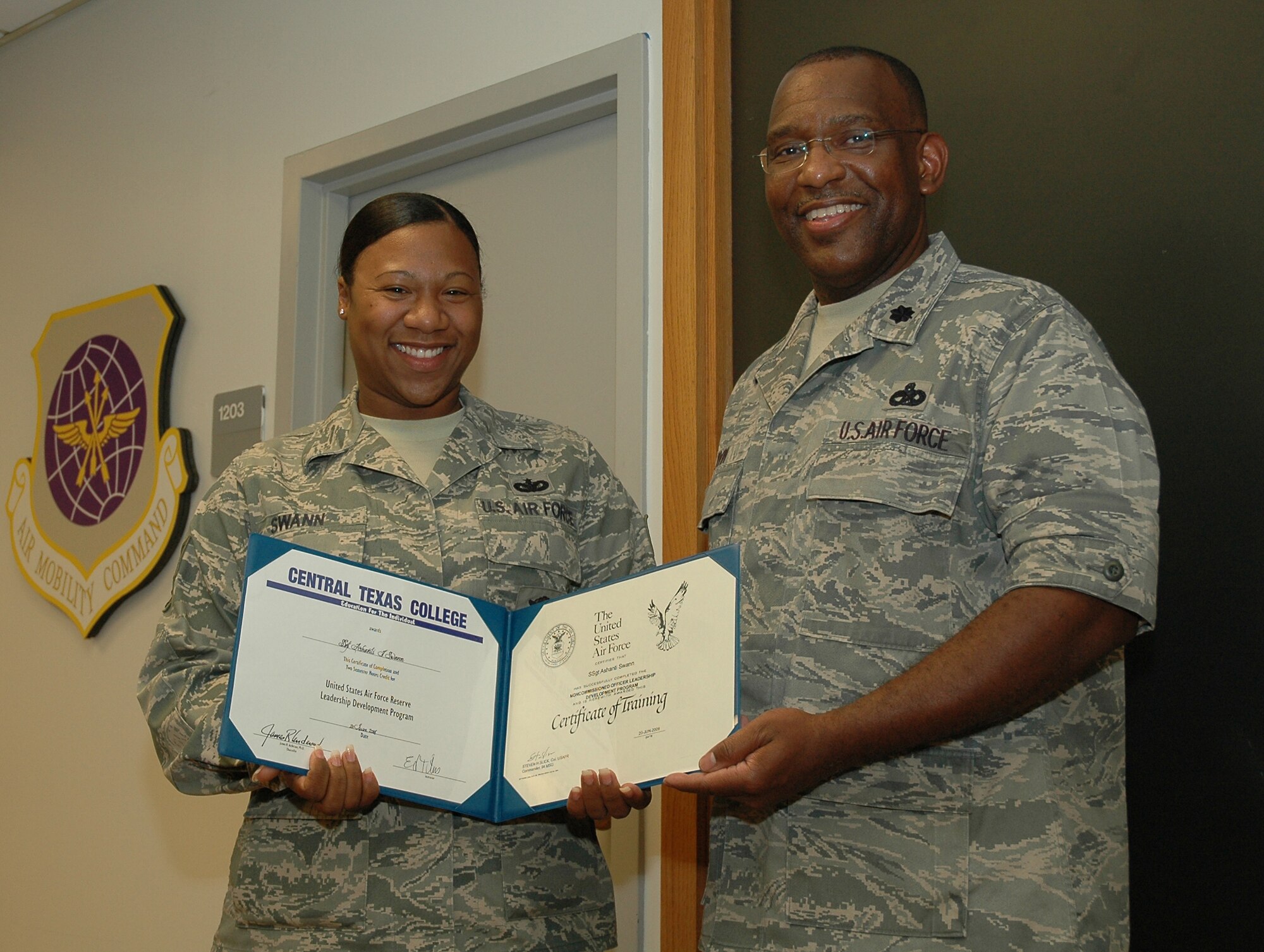Staff Sgt. Ashanti Swann, 94th Security Forces, proudly displays her diploma for the Noncommissioned Officer Leadership Development Program (NCOLDP) course with Lt. Col. Marshall Irving, 94th Support Group deputy commander.  NCOLDP is a 10-day course that provides junior NCOs leadership training.