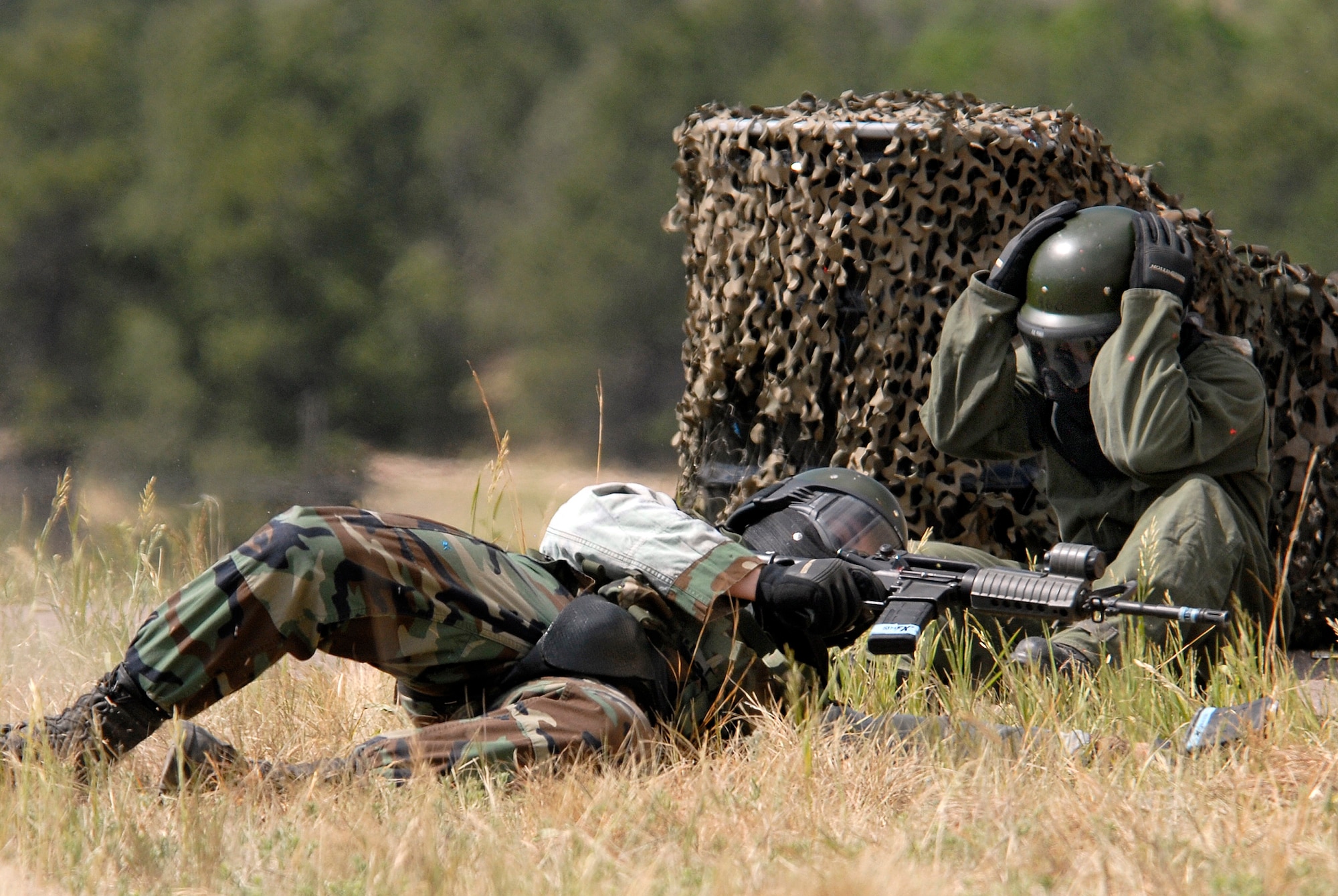 U.S. Air Force Academy cadets take cover during a simulated ground attack against the Military Operations Urban Terrain village during the 71-day summer training schedule June 19 at the Academy in Colorado. Approximately 1,200 Academy cadets are going through intensive training this summer to be ready to be globally engaged when they graduate. (U.S. Air Force photo/Mike Kaplan) 
