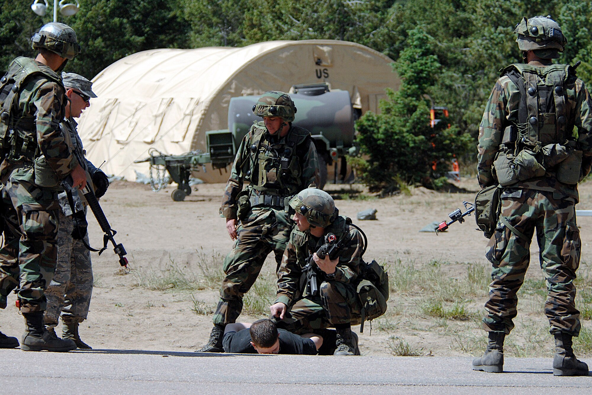 U.S. Air Force Academy cadets practice apprehension techiniques near the Military Operations Urban Terrain village during the 71-day summer training schedule June 18 at the Academy in Colorado. Approximately 1,200 Academy cadets are going through intensive training this summer to be ready to be globally engaged when they graduate. (U.S. Air Force photo/Dave Ahlschwede) 
