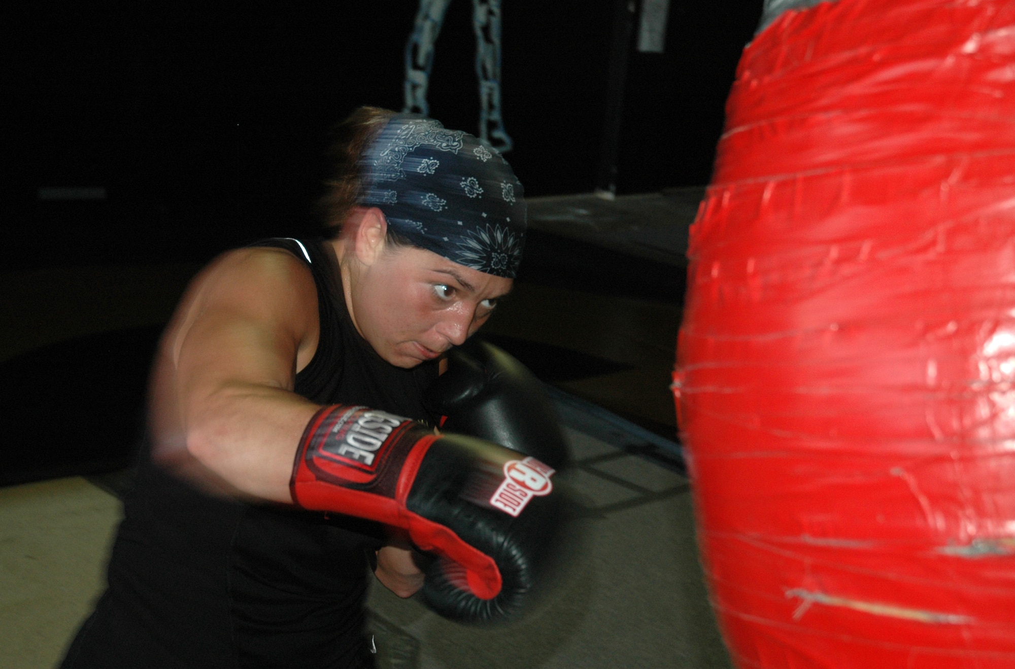 Senior Airman Crystal Wortman makes contact with a punching bag during a training session at a boxing gym in Panama City. (U.S. photo by Staff Sgt. Timothy Capling)