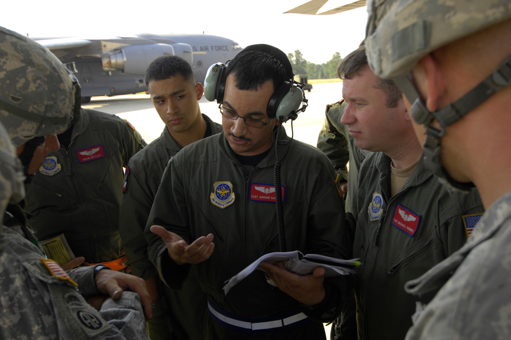 U.S. Air Force Staff Sgt. Adrian Garcia, a C-130 Hercules loadmaster with the 39th Airlift Squadron at Dyess Air Force Base, Texas, explains flight procedures to Army paratroopers before a personnel drop during Joint Forcible Entry Exercise at Pope Air Force Base, N.C., on June 17, 2008. JFEX is a joint airdrop exercise designed to enhance service cohesiveness between U.S. Army and Air Force personnel, allowing both services an opportunity to properly execute large-scale heavy equipment and troop movement. (U.S. Air Force photo by Senior Airman Ali E. Flisek)