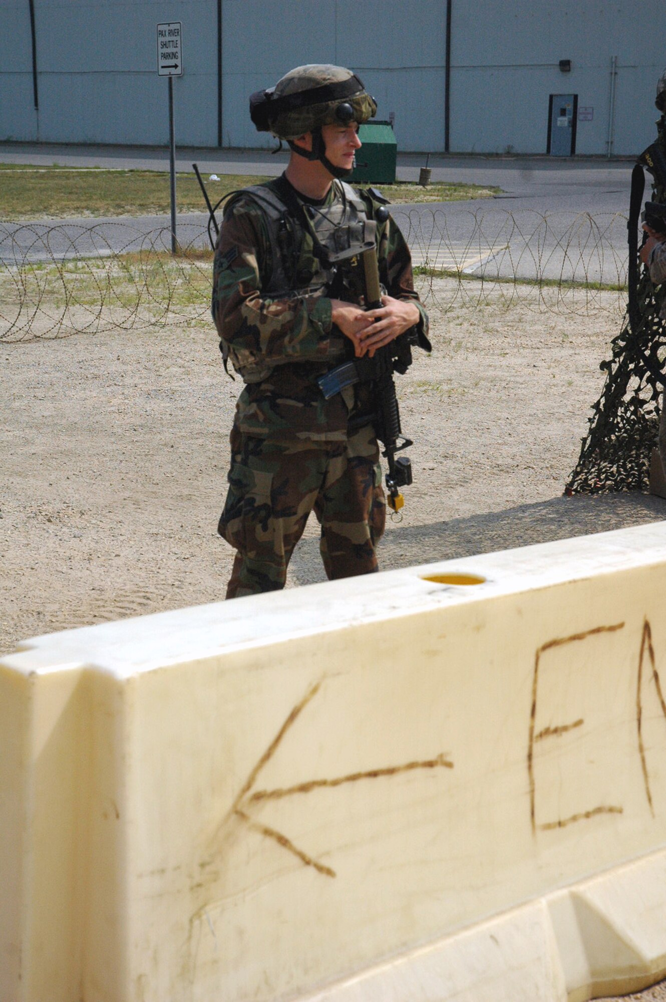 An Airman from the 574th Contingency Response Group, Travis Air Force Base, Calif., watches over an entry control point to the CRG camp as part of Air Force Exercise Eagle Flag 08-5 June 21, 2008, at Naval Air Engineering Station Lakehurst, N.J.  Eagle Flag is operated by the U.S. Air Force Expeditionary Center's Expeditionary Operations School and the 421st Combat Training Squadron at Fort Dix, N.J.  The exercise tests and trains Airmen in expeditionary combat support skills.  (U.S. Air Force Photo/Tech. Sgt. Scott T. Sturkol)