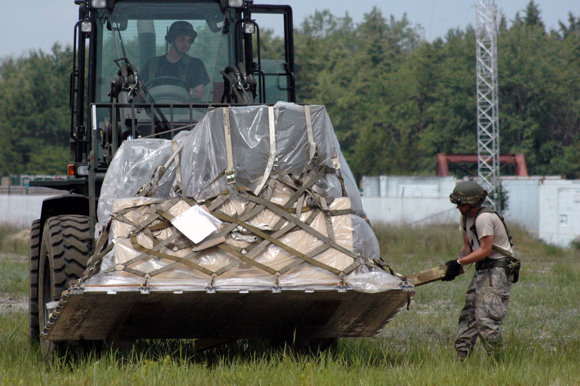 Students for Air Force Exercise Eagle Flag 08-5 move cargo in the main encampment area during operations for the exercise at Naval Air Engineering Station Lakehurst, N.J., June 21, 2008. Eagle Flag is operated by the U.S. Air Force Expeditionary Center's Expeditionary Operations School and 421st Combat Training Squadron at Fort Dix, N.J., and tests and trains Airmen in expeditionary combat support skills.  (U.S. Air Force Photo/Tech. Sgt. Scott T. Sturkol)