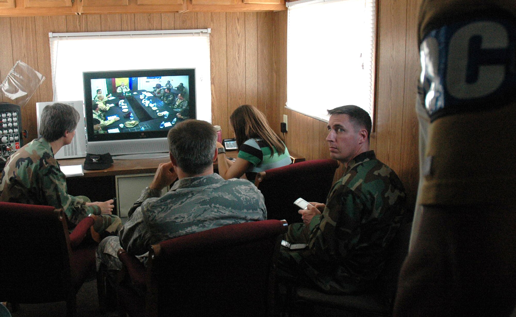Exercise observer/controllers oversee a meeting between deployed Airmen from the "421st Air Expeditionary Group" and the host nation army of "Chimaera" as part of an event for Air Force Exercise Eagle Flag 08-5 at Naval Air Engineering Station Lakehurst.  Eagle Flag is operated by the U.S. Air Force Expeditionary Center's Expeditionary Operations School and 421st Combat Training Squadron at Fort Dix, N.J., and tests and trains Airmen in expeditionary combat support skills.  (U.S. Air Force Photo/Tech. Sgt. Scott T. Sturkol)