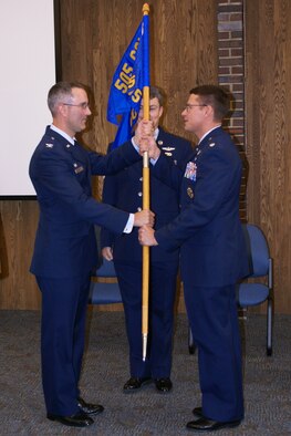Col. Patrick Raglow, left, 505th Operations Group commander, presents Lt. Col. Peter Bastien the Detachment 1, 505th OG flag at the change-of-command ceremony June 13 at the Boeing facility in Kent. (U.S. Air Force photo/Staff Sgt. Eric Burks)