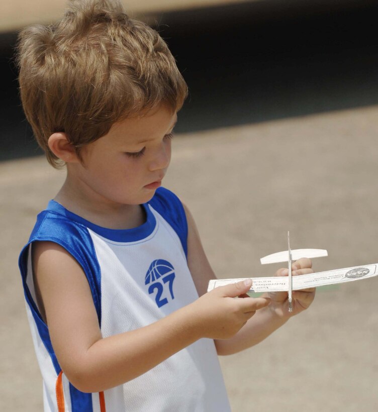 LANGLEY AIR FORCE BASE, Va. – Brandon Tucker, 4, plays with his toy airplane during Air Power over Hampton Roads here June 22.  Langley’s open house is an annual event that helps educate the public, increase recruiting and show appreciation to the local community.  (U.S. Air Force photo/Airman 1st Class Jarrod Chavana)