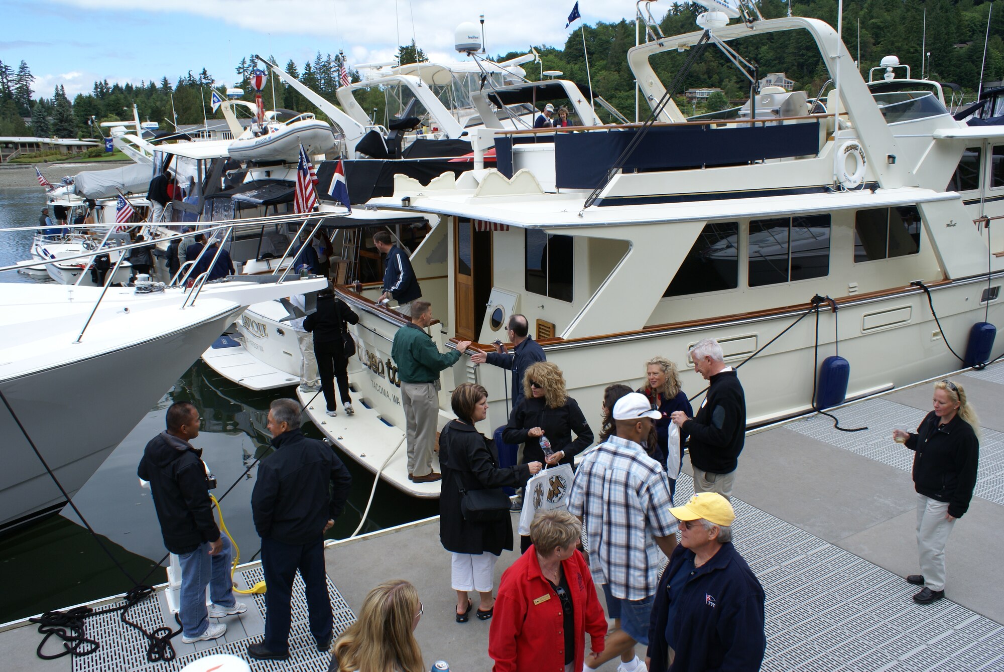 Team McChord members board boats at the Evergreen Fleet Cruise event Wednesday at the Tacoma Yacht Club. Dozens of generous community leaders donated their time and yachts for the annual cruise hosted by the Tacoma-Pierce County Chamber of Commerce, Tacoma Yacht Club and Harborstone Credit Union. The event was designed to unite civic and military leaders. (U.S. Air Force photo/Staff Sgt. Eric Burks) 