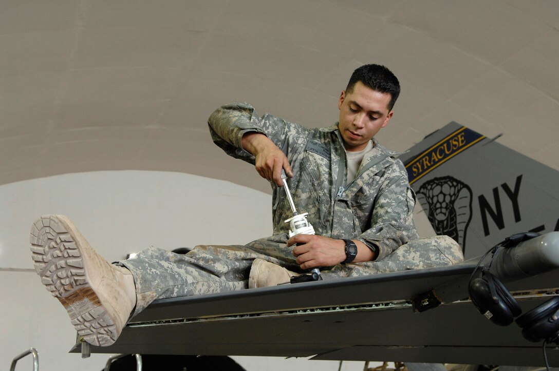 Staff Sgt. Caesar Rivera rotates an actuator for the leading edge flap test of an F-16 Fighting Falcon during a phase inspection June 18 at Joint Base Balad, Iraq. The leading edge flap provides additional lift and drag during take off and landing. Sergeant Rivera is a 332nd Expeditionary Aircraft Maintenance Squadron crew chief deployed from Nellis Air Force Base, Nev. (U.S. Air Force photo/Senior Airman Julianne Showalter) 