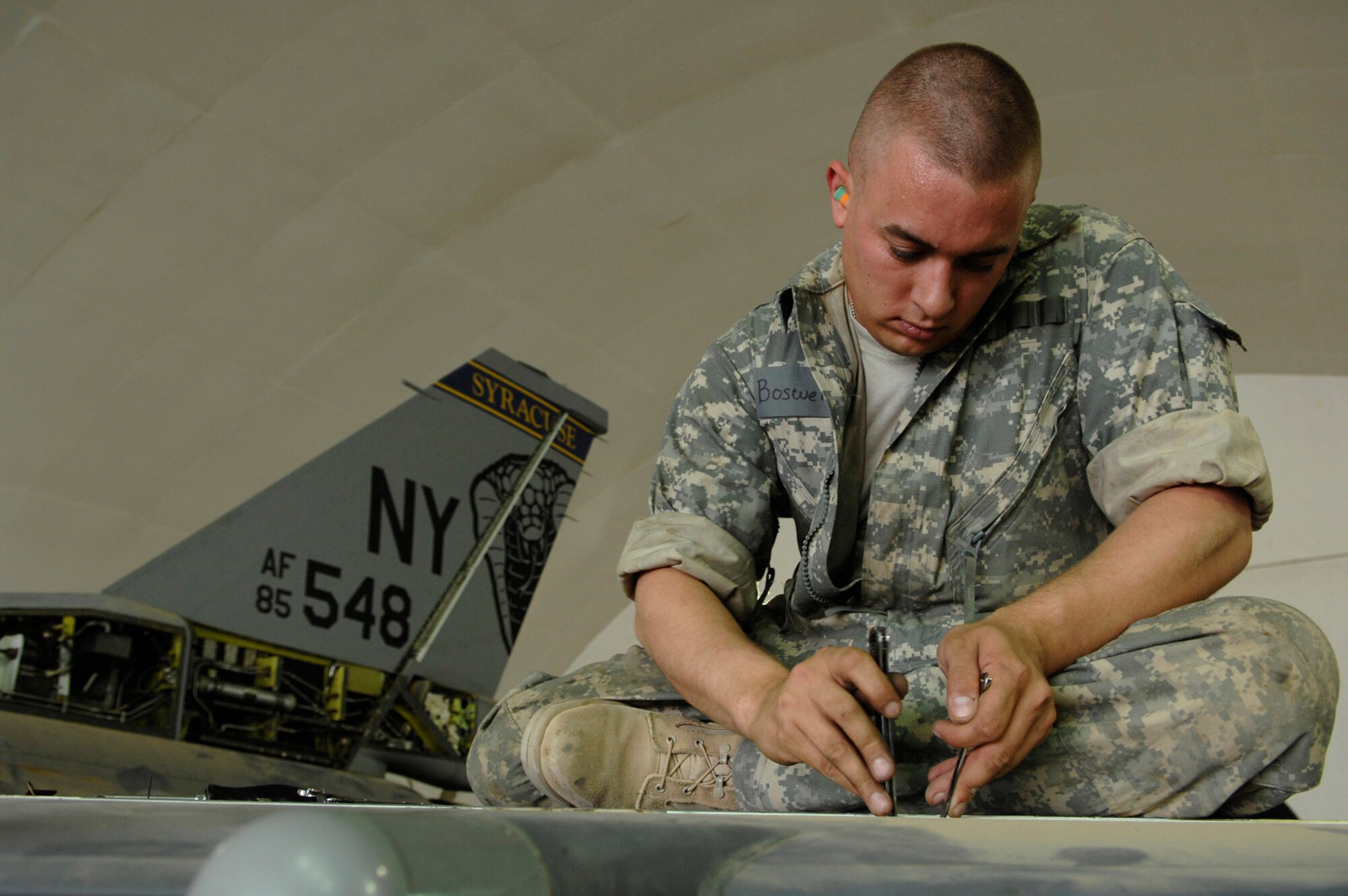Airman 1st Class Bryan Boswell reinstalls an actuator for the leading edge flap test of an F-16 Fighting Falcon during a phase inspection June 18 at Joint Base Balad, Iraq. The leading edge flap creates a cup-like channel of air under the wings, which allows the aircraft to move at slower air speeds. Airman Boswell is a 332nd Expeditionary Aircraft Maintenance Squadron crew chief deployed from Nellis Air Force Base, Nev. (U.S. Air Force photo/Senior Airman Julianne Showalter) 
