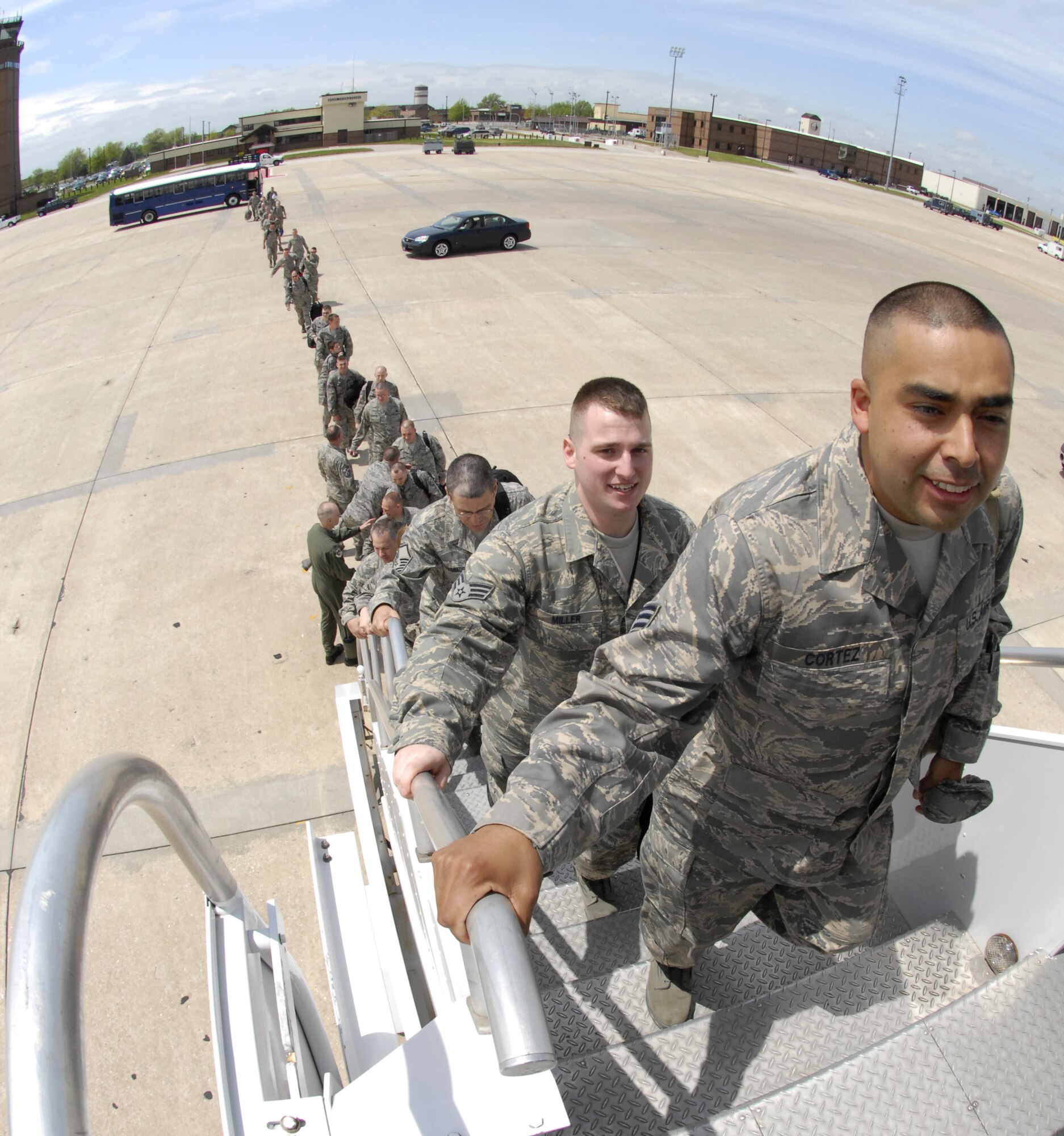 Senior Airmen Ulisses Cortez and Timothy Miller lead a line of Air Force Reservists from the 442nd Maintenance Group up the stairs to a waiting Boeing 767 at Whiteman Air Force Base, Mo., May 6, 2008, enroute to Afghanistan to support Operation Enduring Freedom.  This is the fourth deployment of A-10 Thunderbolt II aircraft and Citizen Airmen to support the Global War Against Terror.  Citizen Airmen from the 442nd Fighter Wing, based at Whiteman, deployed for 45 days to Bagram Air Base, Afghanistan, to maintain aircraft and fly combat sorties to support ground troops there.  (U.S. Air Force photo/Maj. David Kurle)