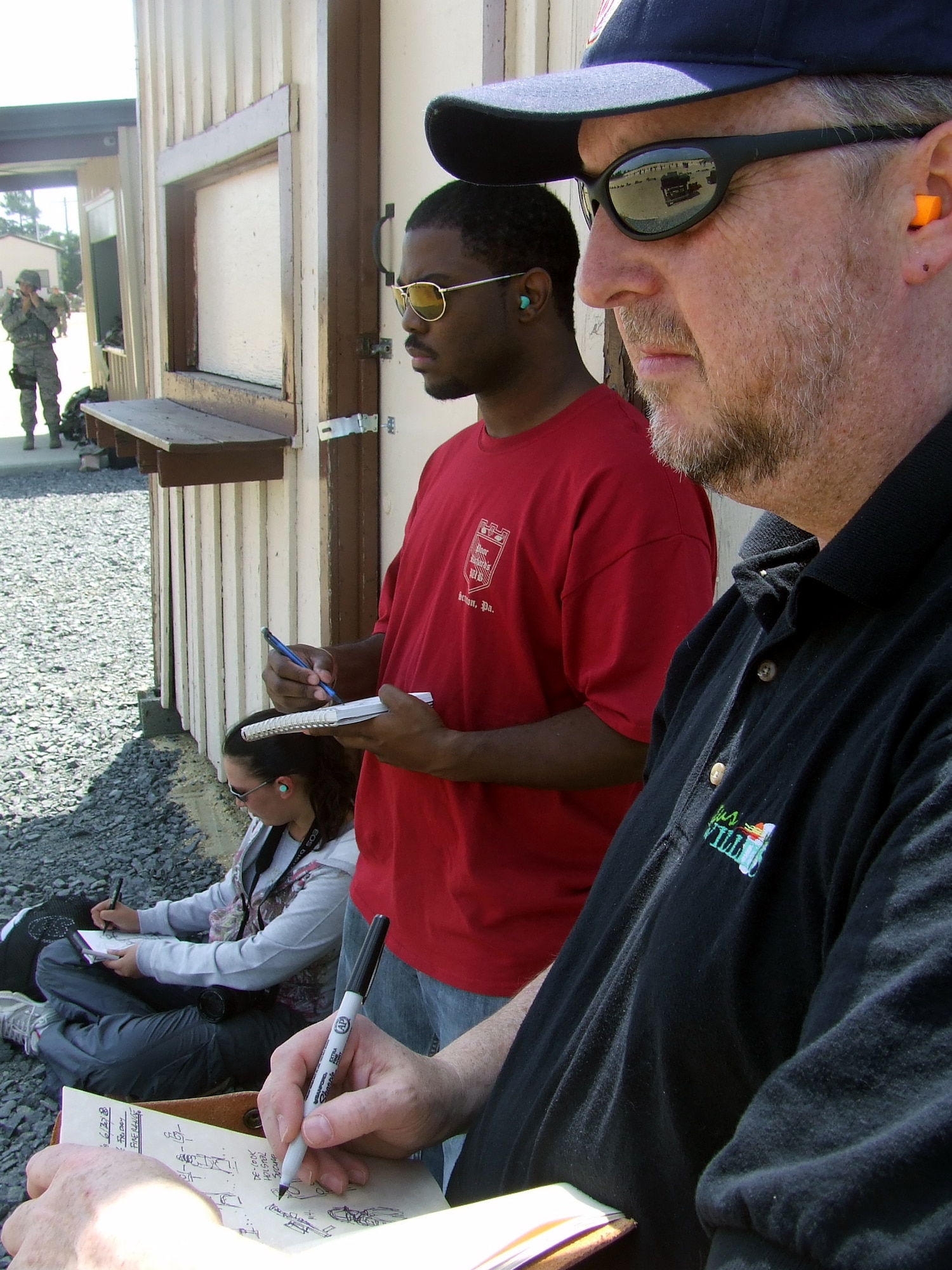 Artists Tatiana El Khouri, Steven Walker and William Frake sketch a scene during a visit to Fort Dix, N.J., range to document the Air Force Phoenix Warrior Training Course for the Air Force Art Program June 20, 2008.  They were three of five artists visiting the U.S. Air Force Expeditionary Center and its courses to create future works of art for the program.  (U.S. Air Force Photo/Tech. Sgt. Scott T. Sturkol)
