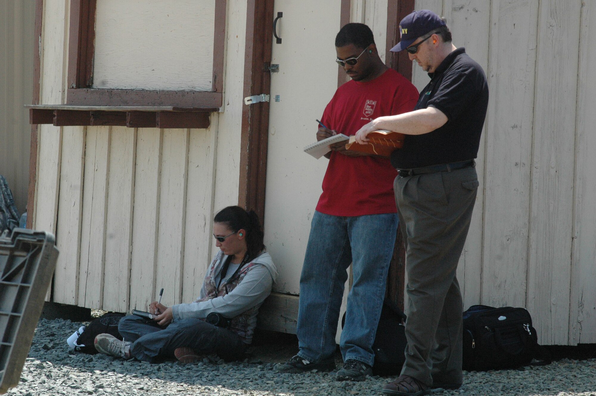 Artists Tatiana El Khouri, Steven Walker and William Frake sketch a scene during a visit to Fort Dix, N.J., range to document the Air Force Phoenix Warrior Training Course for the Air Force Art Program June 20, 2008.  They were three of five artists visiting the U.S. Air Force Expeditionary Center and its courses to create future works of art for the program.  (U.S. Air Force Photo/Tech. Sgt. Scott T. Sturkol)