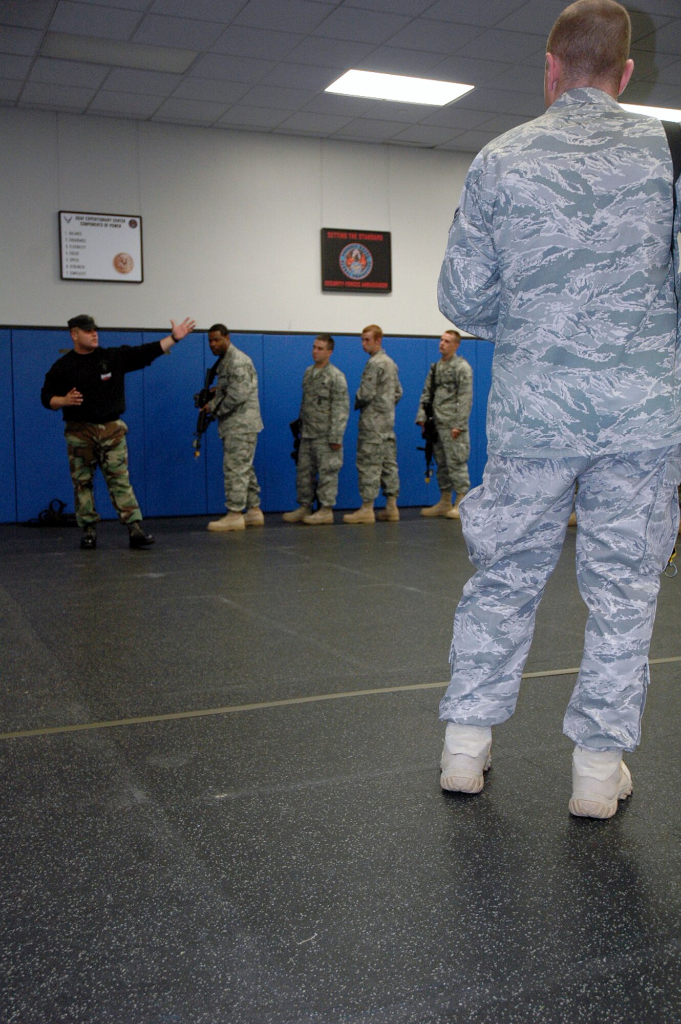 Instructor Staff Sgt. Thomas Carpino of the 421st Combat Training Squadron works with students in the Air Force Phoenix Warrior Training Course during "tape drills" for training in mobile operations in urban terrain in the U.S. Air Force Expeditionary Center June 19, 2008, on Fort Dix, N.J.  The course, taught by the USAF EC's Expeditionary Operations School and the 421st CTS, prepares security forces Airmen for upcoming deployments.  (U.S. Air Force Photo/Tech. Sgt. Scott T. Sturkol)