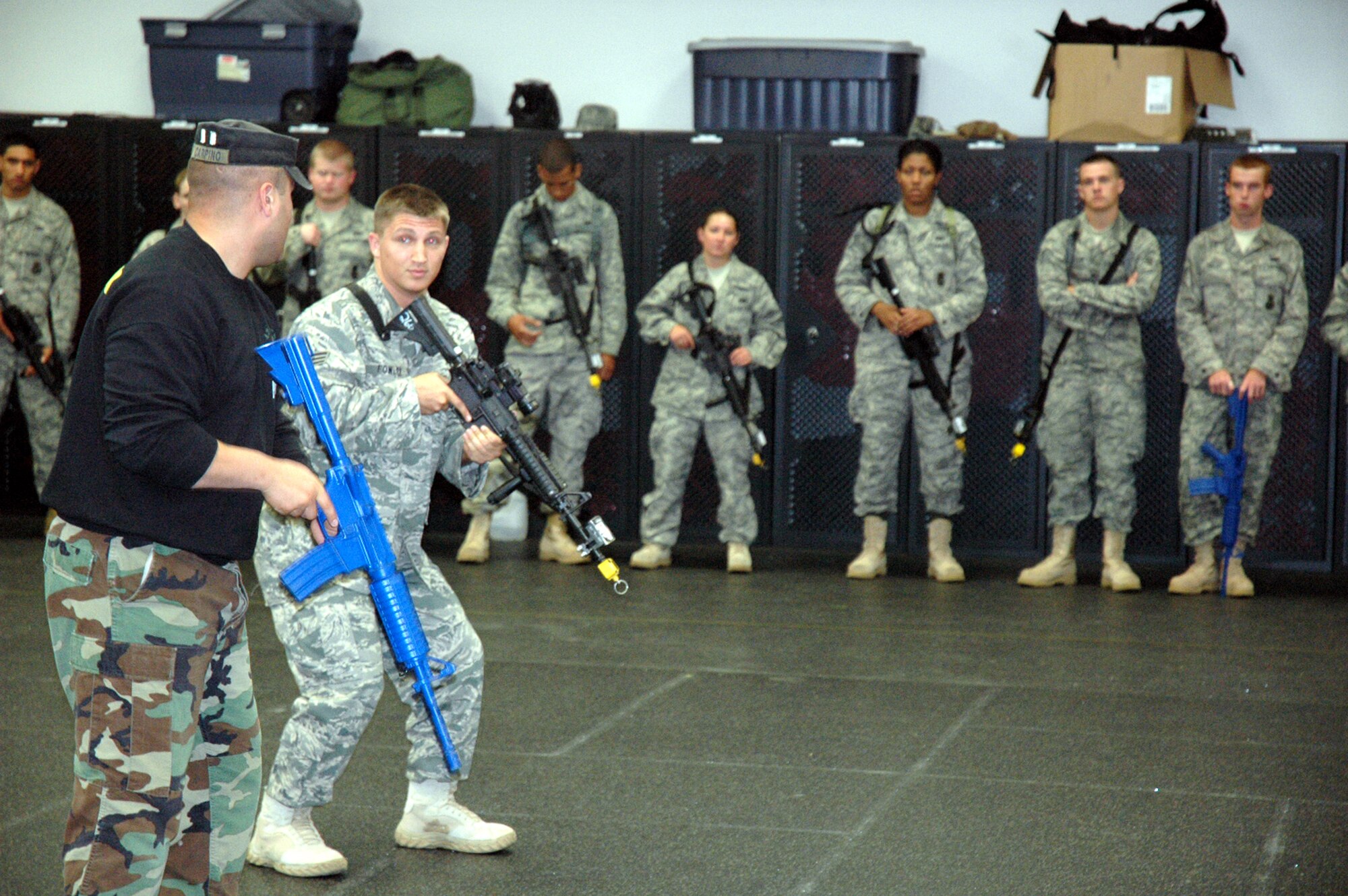 Instructor Staff Sgt. Thomas Carpino of the 421st Combat Training Squadron works with students in the Air Force Phoenix Warrior Training Course during "tape drills" for training in mobile operations in urban terrain in the U.S. Air Force Expeditionary Center June 19, 2008, on Fort Dix, N.J.  The course, taught by the USAF EC's Expeditionary Operations School and the 421st CTS, prepares security forces Airmen for upcoming deployments.  (U.S. Air Force Photo/Tech. Sgt. Scott T. Sturkol)