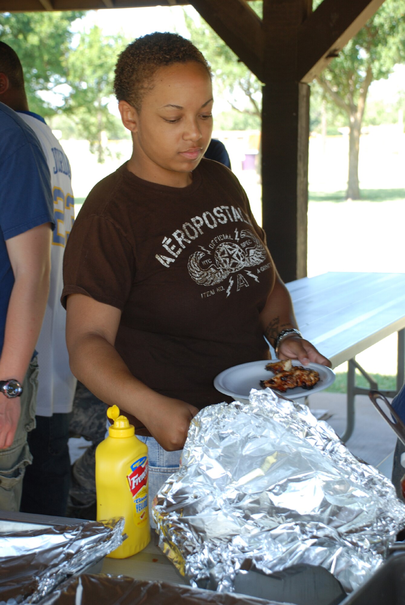 Airman 1st Class Jasmine Simpson, a personnelist for the 882nd Training Squadron, goes through the food line at the permanent party dorm barbeque June 20. (U.S. Air Force photo/Airman 1st Class Candy Miller)
