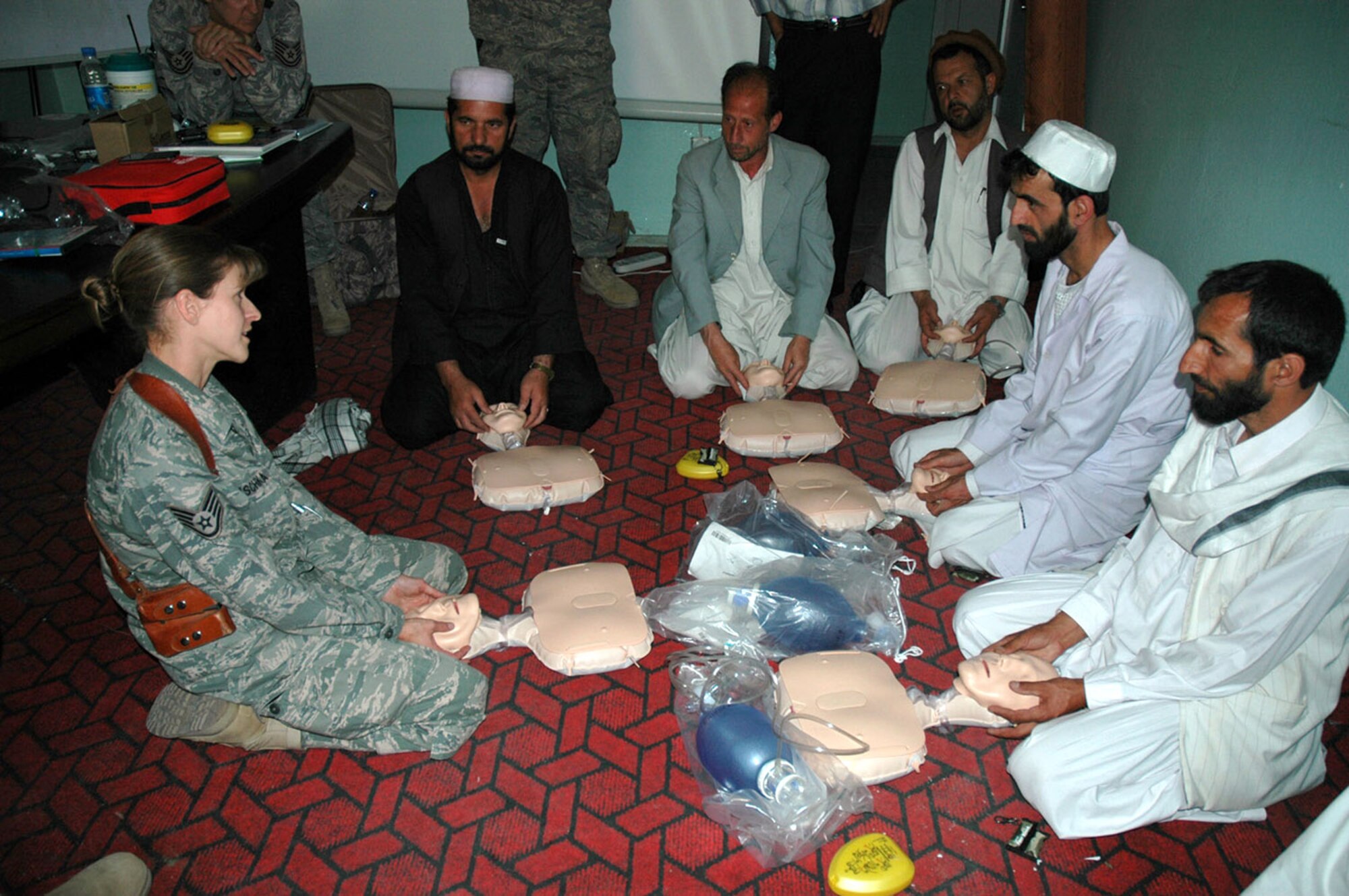Staff Sgt. Janine Duschka teaches infant CPR to Afghan medical providers during a CPR class June 18 at the Rokha Clinic in the Panjshir Province in Afghanistan. This was the first session of a 15-class CPR program that the Panjshir PRT is providing this year. Sergeant Duschka is a Panjshir Provincial Reconstruction Team medical technician. (U.S. Air Force photo/Capt. Jillian Torango) 
